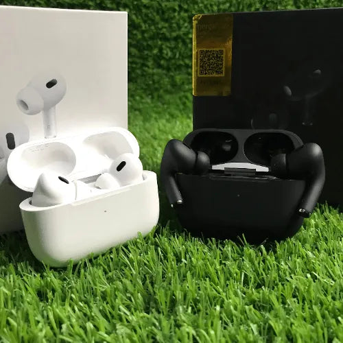 White wireless earbuds in a charging case on grass with a black case in the background.
